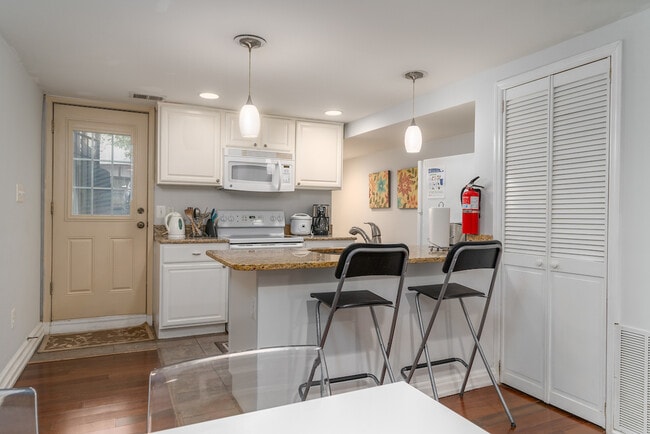 kitchen and breakfast nook with view of back door
