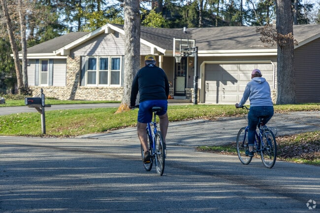 A couple getting exercise in the Jamestown neighborhood by riding their bikes together.