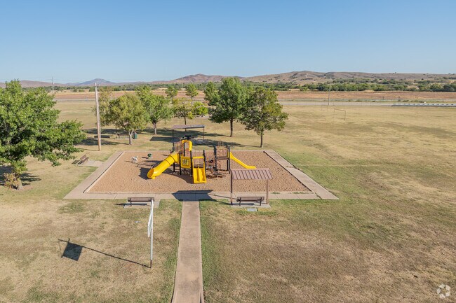 The playground at Albert Johnson Park offers views of the Wichita Mountains in the distance.