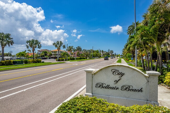 Belleair Beach’s entry sign stands near palm-lined roads and waterfront homes.