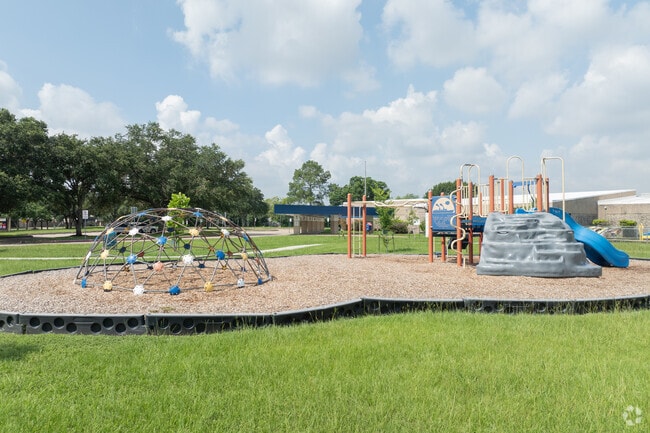 Students enjoy a colorful playground and a basketball court for recreation.