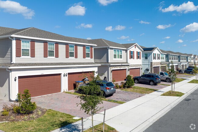 In Intercession City, a row of new townhouses showcases well-maintained landscaping.