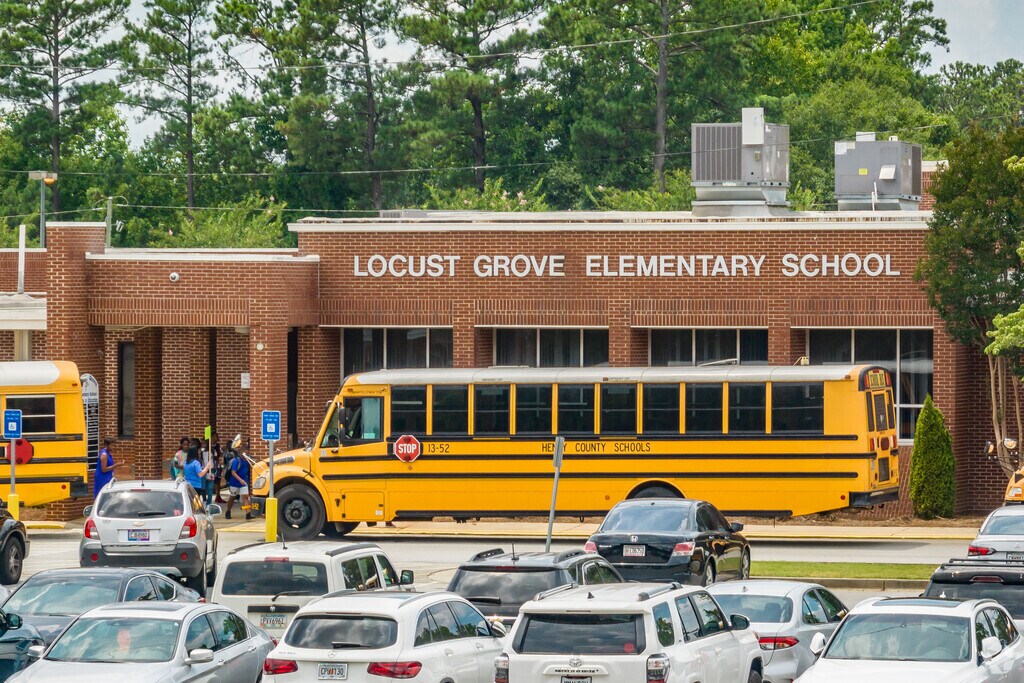 Kids line up to get on the bus at the end of the day at Locust Grove Elementary School.