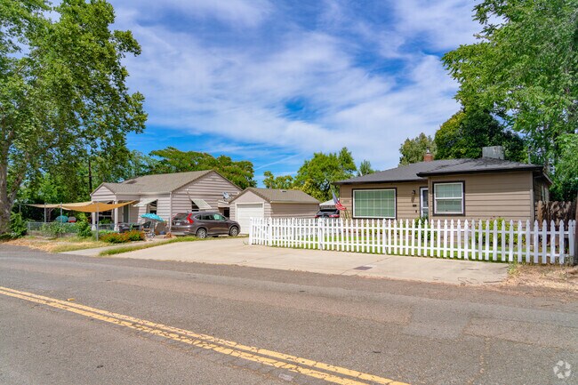 White picket fence lines commonly found single story ranch style homes in Downtown Redding.