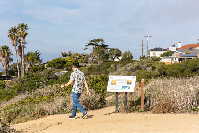 A man embarks on a trail to meet for a date along the cliffs.