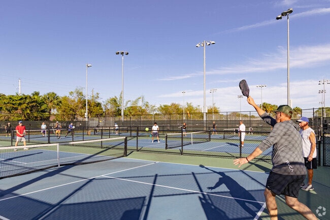Palm Springs Village residents enjoy a spirited game of pickleball, fostering community bonds.