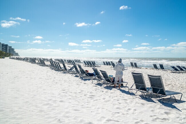 Close by Pelican Bay,  the beach at Clam Pass has rows of beach chairs waiting for beach goers.