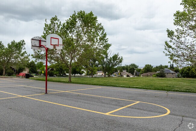 Basketball courts at Reading Elementary school are surrounded by trees.