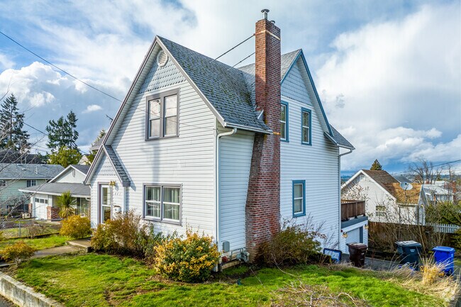 This multi-tier home features a brick chimney.