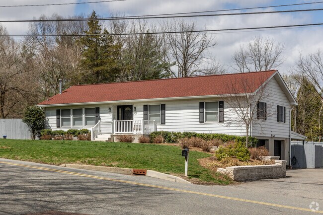 This raised ranch-style home in Glen Gardner features a spacious layout and elevated design.