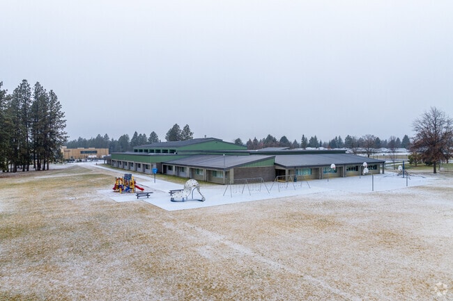 Mullen Road Elementary features a small playset behind the school.