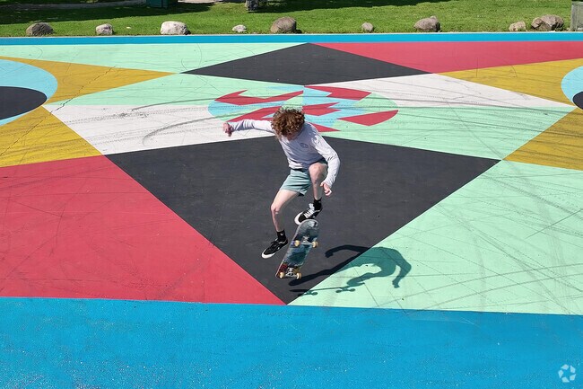 A skateboarder shreds on a basketball court in Tiefenthaler Park.