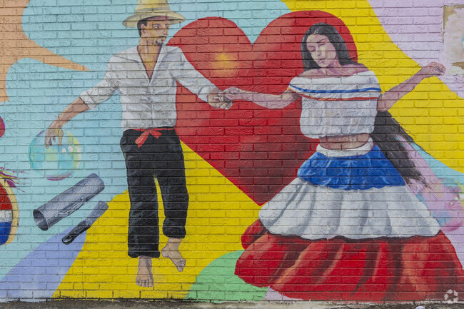 A vibrant mural near North Common celebrates Lawrence's cultural roots and artistic spirit through bold color and powerful imagery.