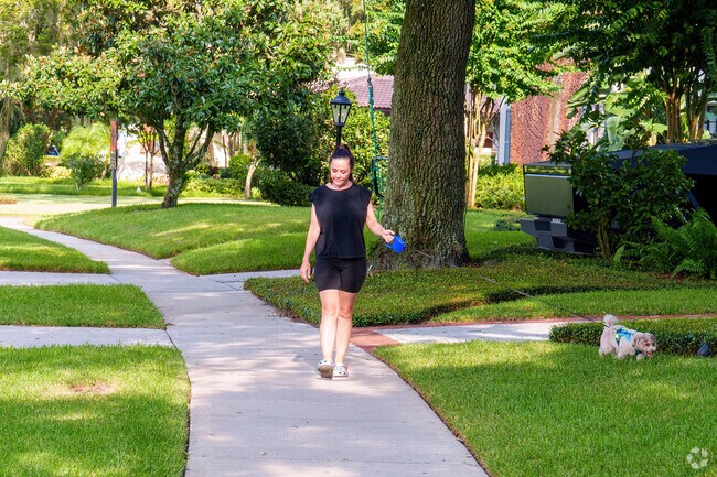 A resident enjoys a relaxing afternoon walk with her dog.