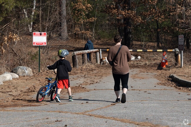 Families enjoy the trails that wind around Massabesic Lake in Youngsville.