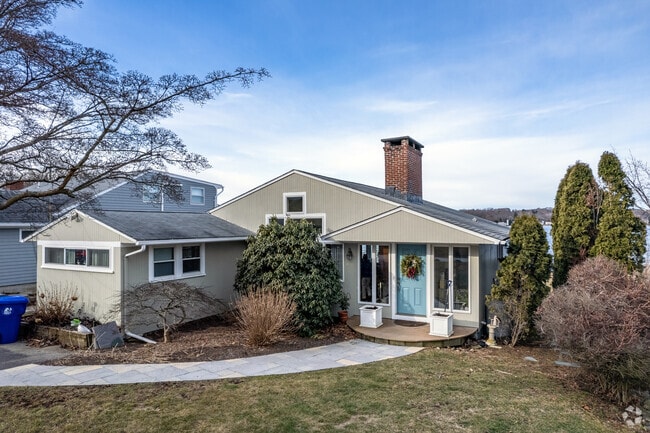 Touisset Highlands home sits right on the water with a well-kept yards and low-profile designs.