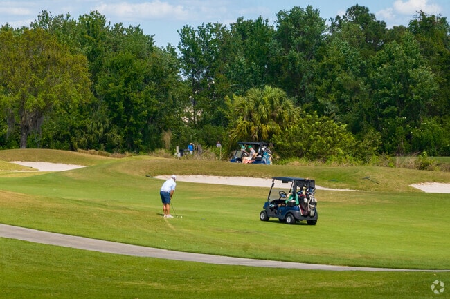 Golfers enjoy a beautiful day at Celebration Golf Club