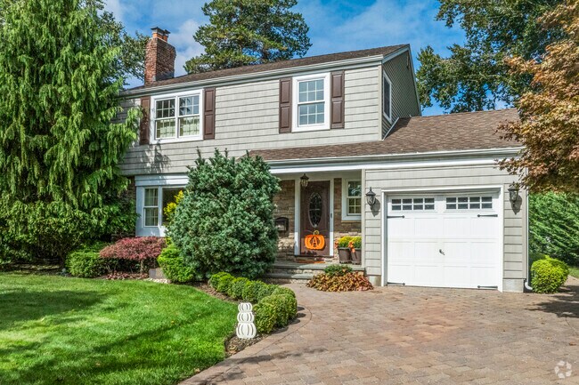 Contemporary colonial style homes often feature expansive front yards with green space.
