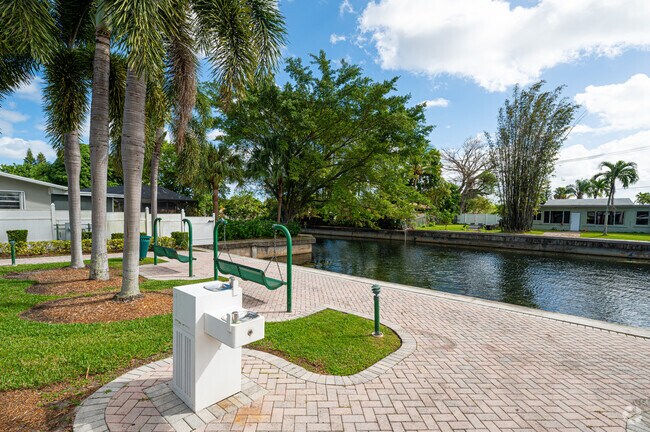 Margate Gardens locals enjoy the scenic water view from the swinging benches at Legacy Park.