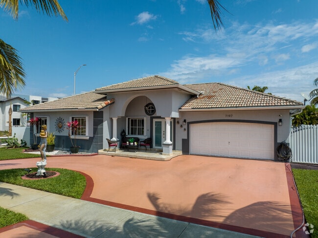 The Amelia District in Miami, FL has plenty of single-family homes with tropical trees.