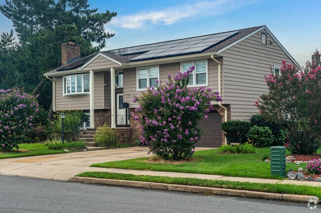 Homes are often landscaped with colorful flowers and plants in Moonachie.