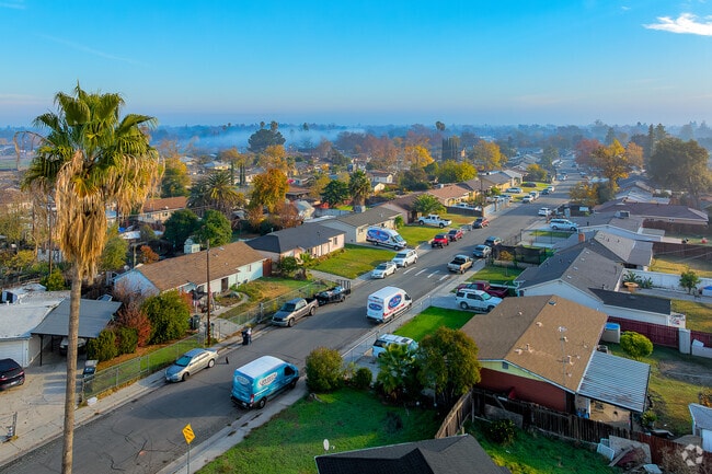 Sun peeks through the clouds and lights up homes in Richardson Village at sunrise.