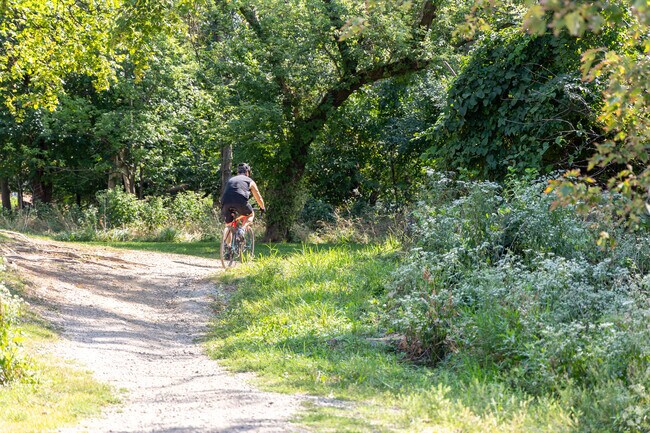 On one of the many outdoor paths, a resident of River Grove rides a mountain bike.
