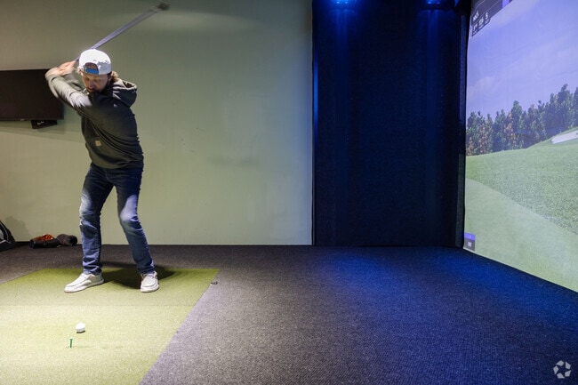 NextGen Golf in Malta offers virtual golf games in a sleek, modern indoor setting.