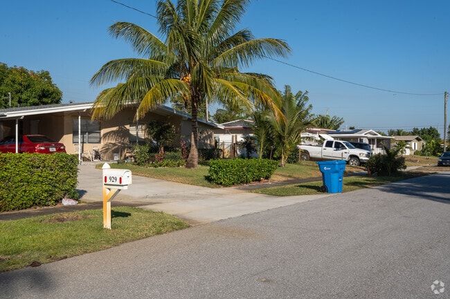 Homes in Lantana Pines are lined with palm trees and lush foliage.