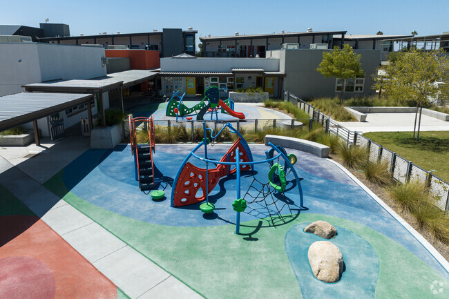 colorful play area with exercise structures for kids to climb.