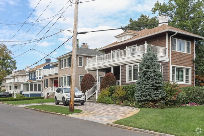 Smaller Woodsburgh homes maintain charm with well-kept yards and landscaping.