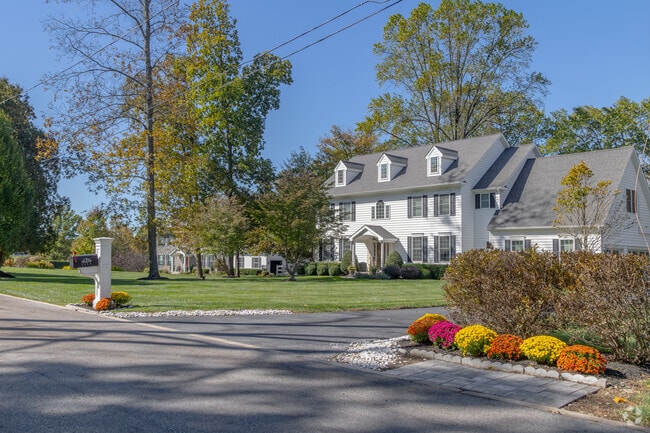 Colonial Revival homes sit back on spacious lots with manicured lawns and mature trees.