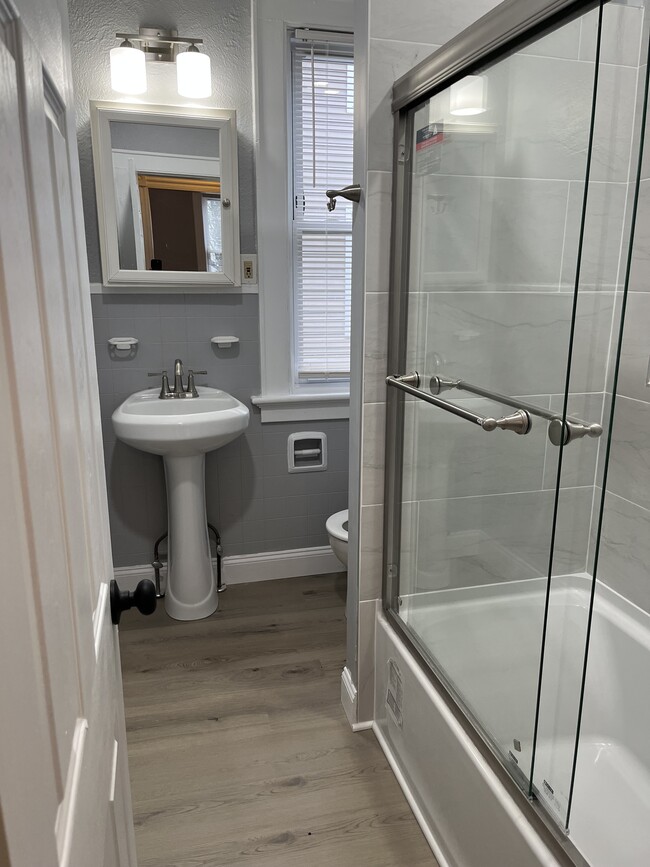 Completely remodeled full bathroom. New tub, tiling, flooring, lighting, pedestal sink, fixtures and