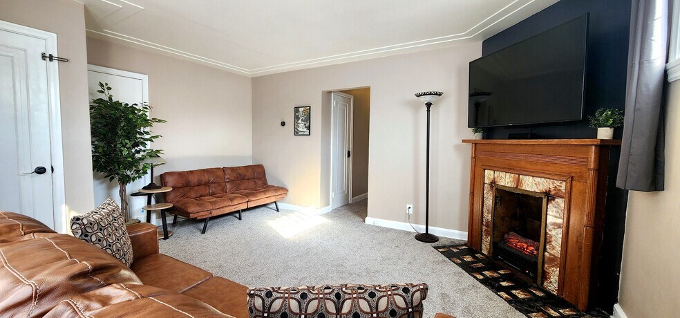 Living Room with Smart TV & Electric Fireplace Spacious lounge featuring a 55” Samsung Smart TV+Roku