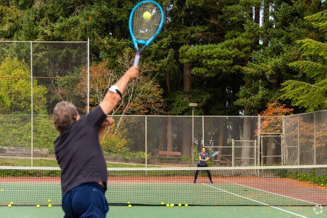 Locals practice their swing at the tennis courts in the Town Center Evergreen Playfield.