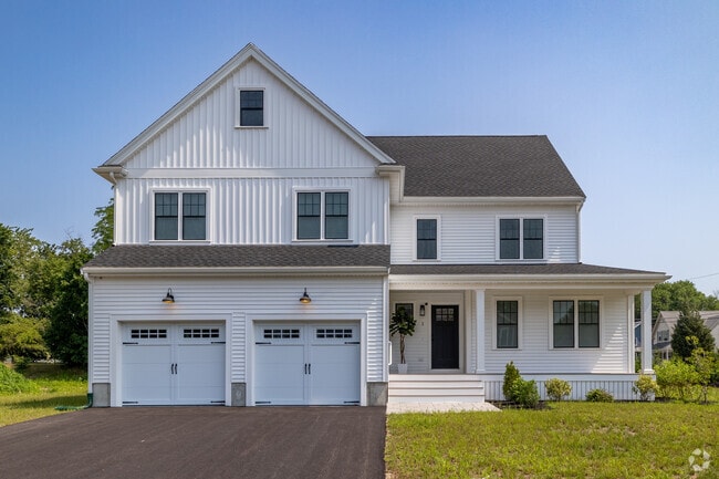 This stunning Farmhouse Colonial sits on a perfectly manicured lawn in Holbrook.