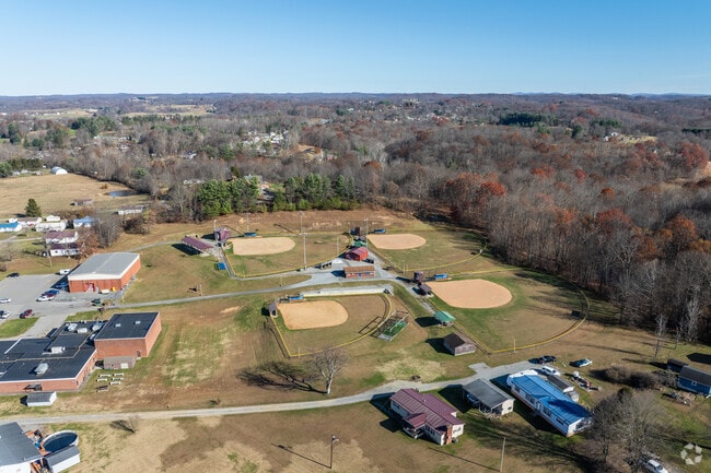 The students attending Tennerton Elementary School have fun playing ball on the baseball diamonds behind the school.