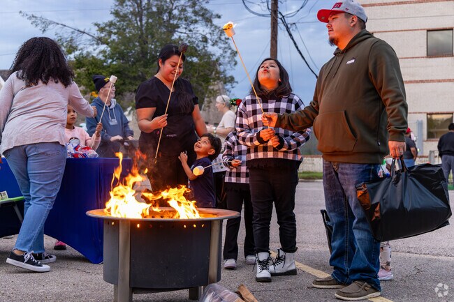 A family roasts marshmallows over an open fire at the Downtown Cocoa Crawl.