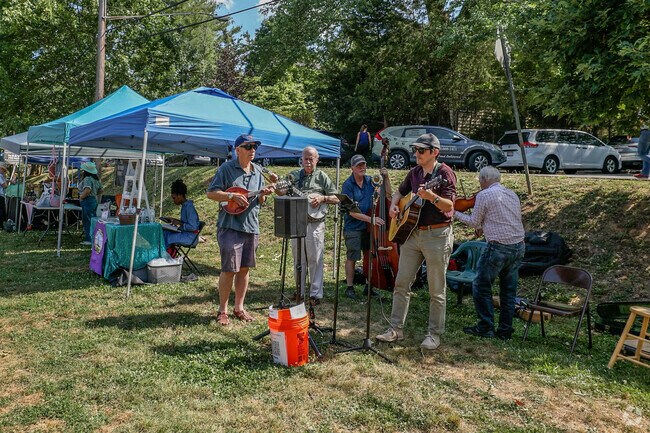 Melodies fill the air at Brookmont's lively farm market, a harmonious community gathering.
