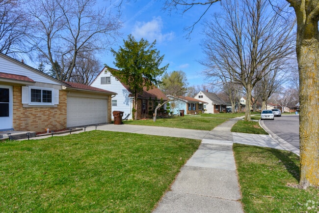 A street of ranches and Cape Cods on a tree-lined street in Churchill Downs.