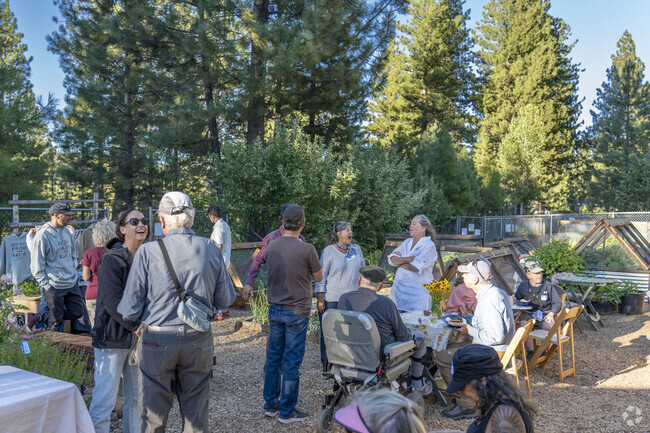 The Slow Summer Soirée sets up the event in the middle of the community garden.