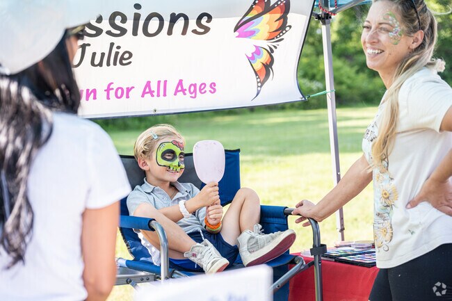 A local Dartmouth boy admires the handiwork of his face-paint artist at the farmers' market.