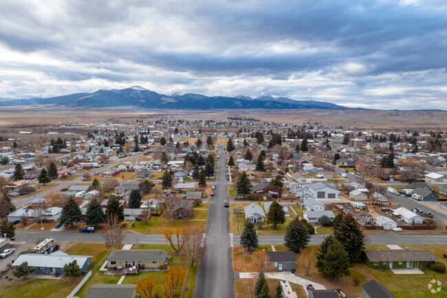 Deer Lodge homes are framed by scenic landscapes and open skies.