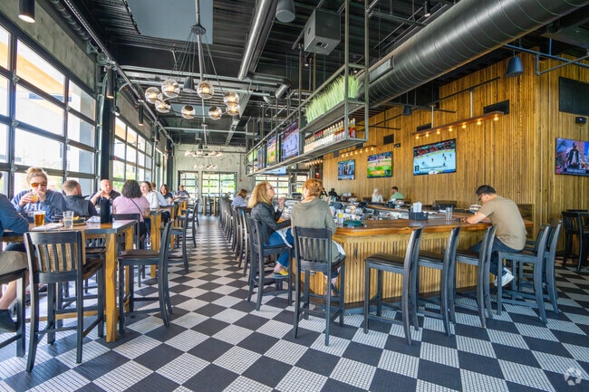 Residents of Mishawum enjoy food and drinks at the Tavern in the Square.