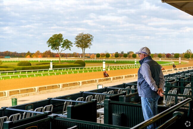 A resident of Firmantown enjoys arriving early at Keeneland to watch the horses warm up.