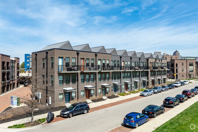 New apartments and condos, including Gravity Project phases, rise beside historic blocks.