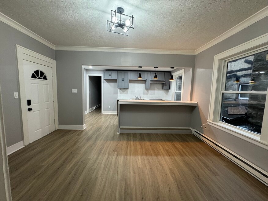 Main Living Area (Wide View)- Spacious living room with beautiful natural light and updated flooring