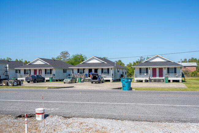 A line of identical simple white cottages on Route 3161 in Cut Off.