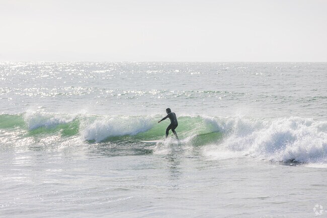 Catching waves at El Granada's prime surfing spot.