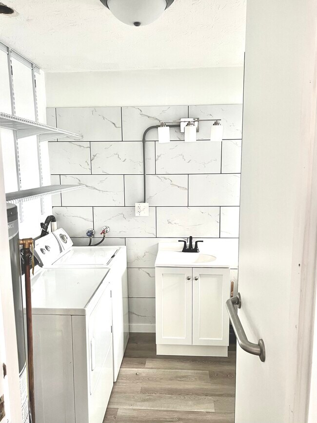 full bath with washer/dryer hookup and storage